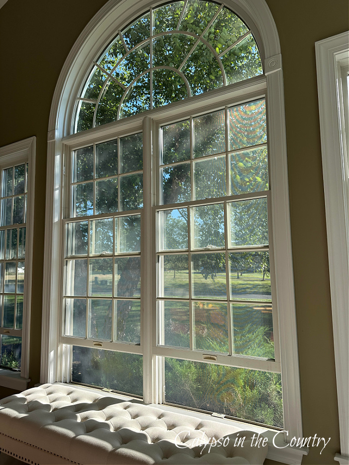 Large arched windows open with bench below - August recap
