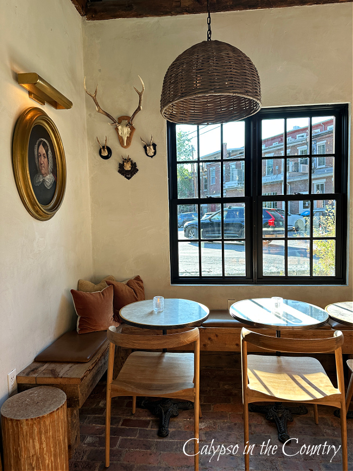 Corner table below black windows and hanging woven pendant - mid-september vibes