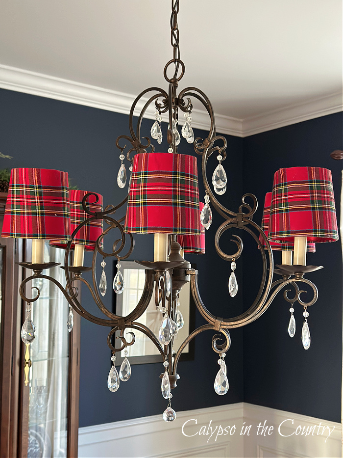 DIY plaid lampshades on chandelier in navy blue dining room