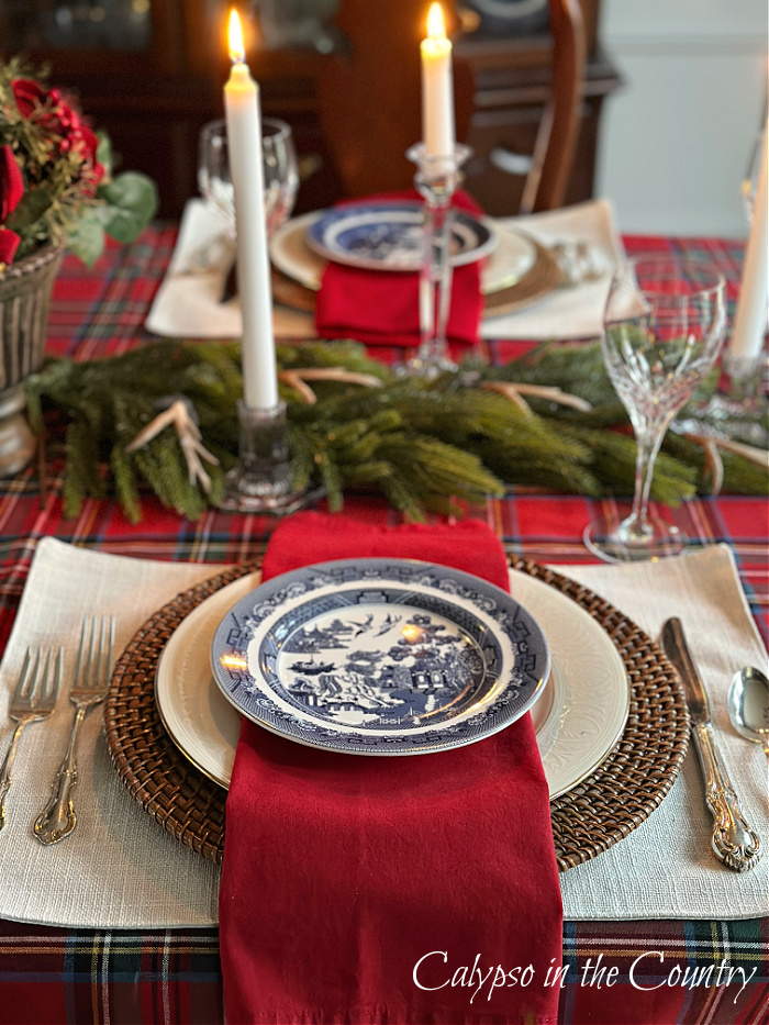 Dining table place settings with blue plates and red napkins - Ralph Lauren Christmas Dining Room