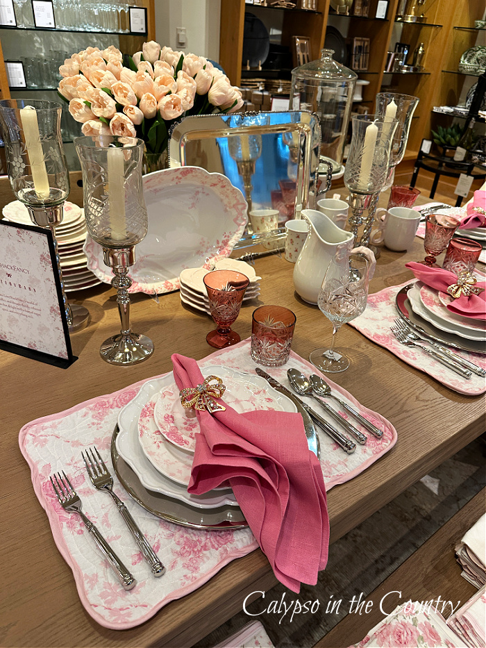 Store display with pink and white table settings 