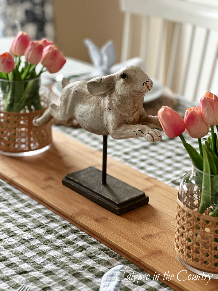Leaping bunny centerpiece with pink tulips on table - simple Easter brunch table setting