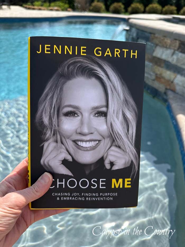 Jennie Garth - I Choose Me book held in front of pool - April Wrap Up