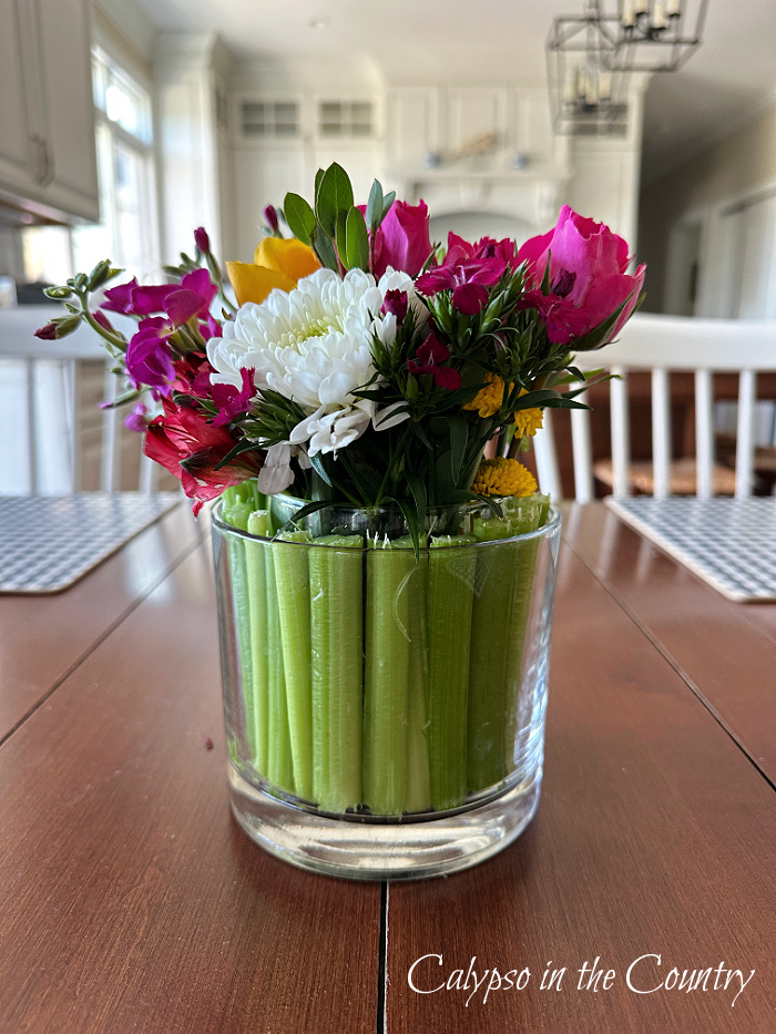 flowers in celery vase on table