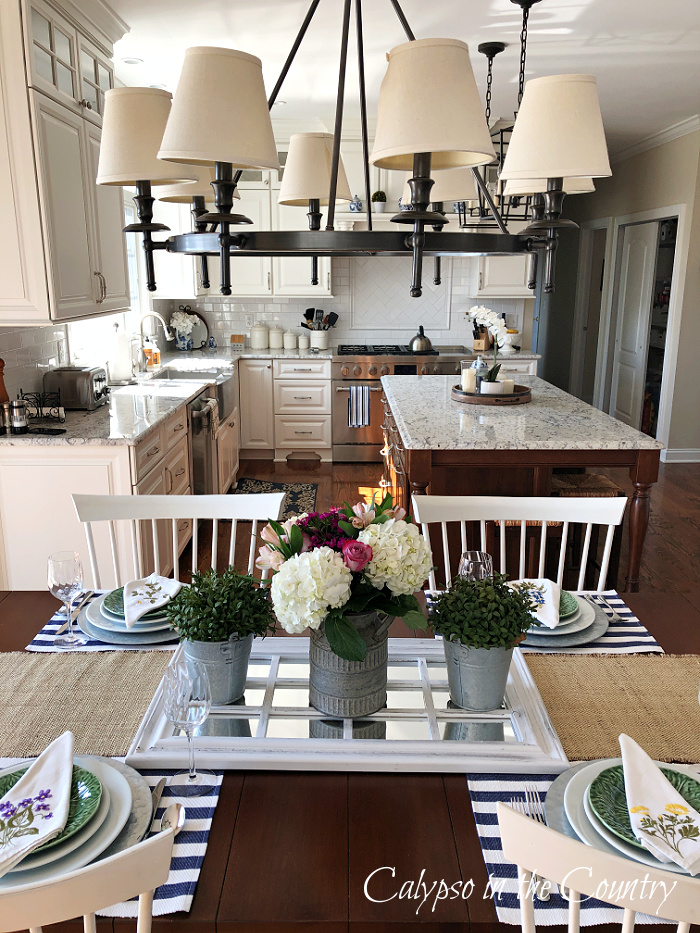 Spring tablescape with hydrangeas and galvanized containers on window pane mirror - garden inspired home decor