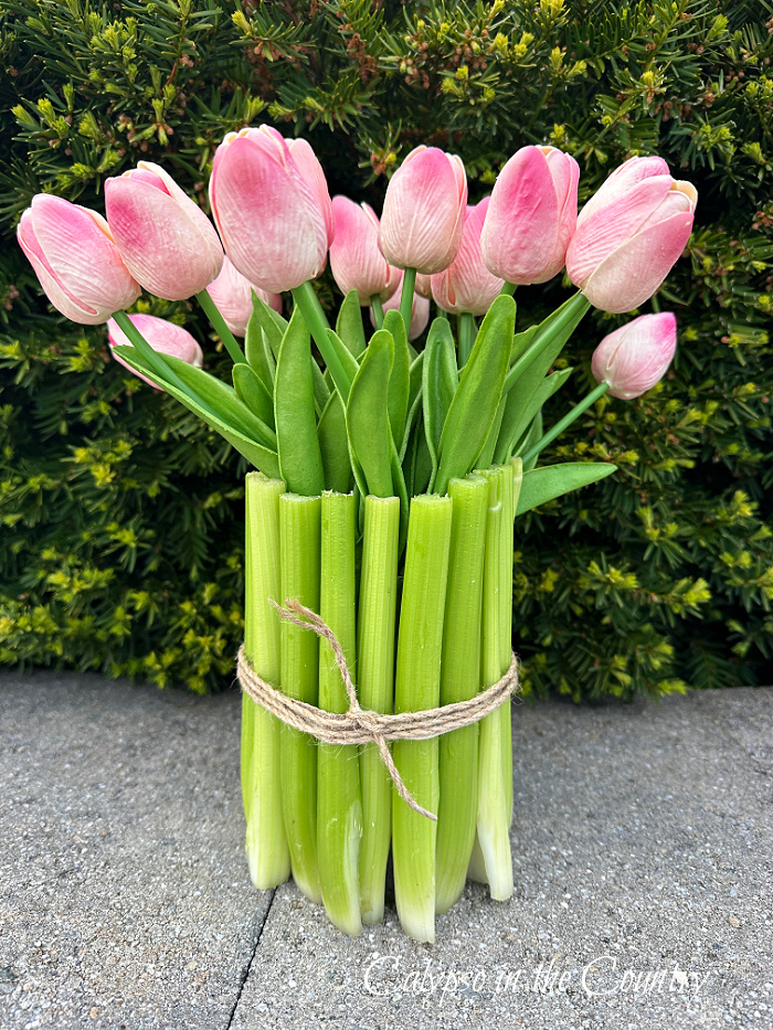 Pink tulips in vase wrapped in celery and twine - garden inspired home decor