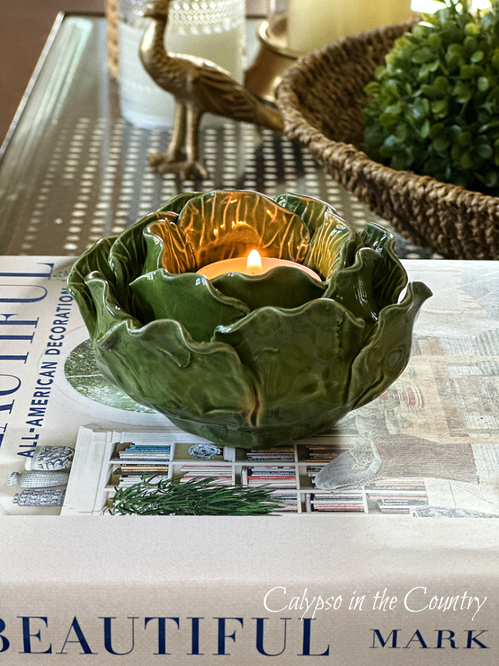 Green cabbage candle on stack of books - March wrap up