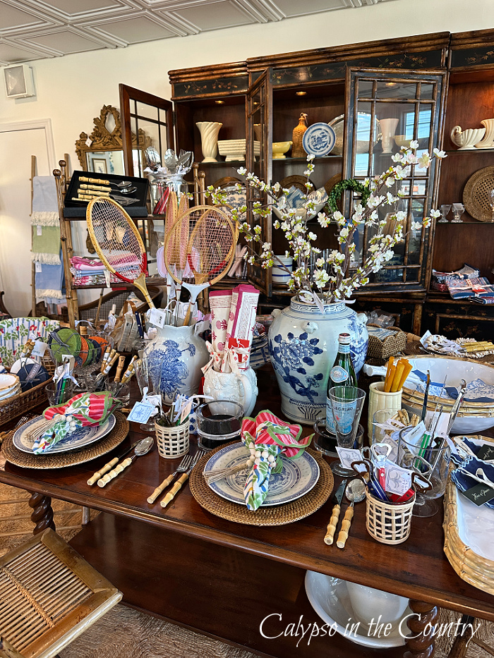 Blue and white porcelain and table ware on wood table in front of china cabinet - April Wrap Up