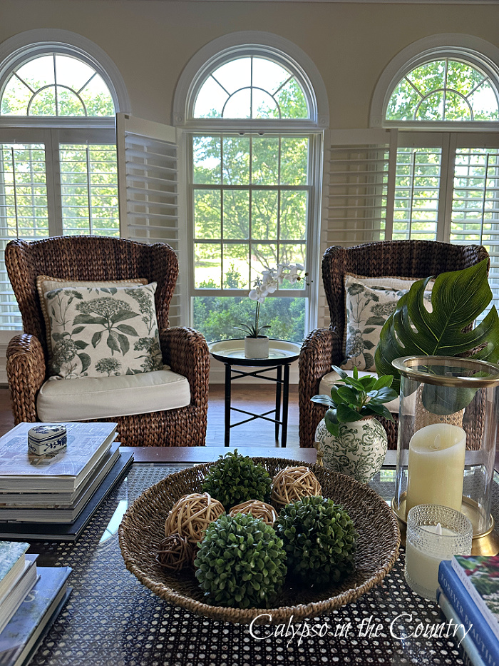 seagrass chairs in front of three arched windows - May wrap up
