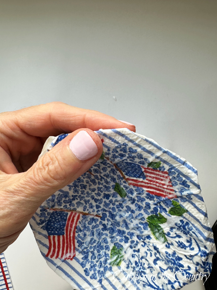 Hand applying napkin to shell - how to decoupage shells