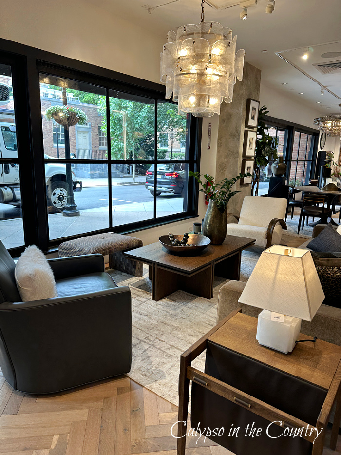 Modern furniture display next to black paned window - June wrap up