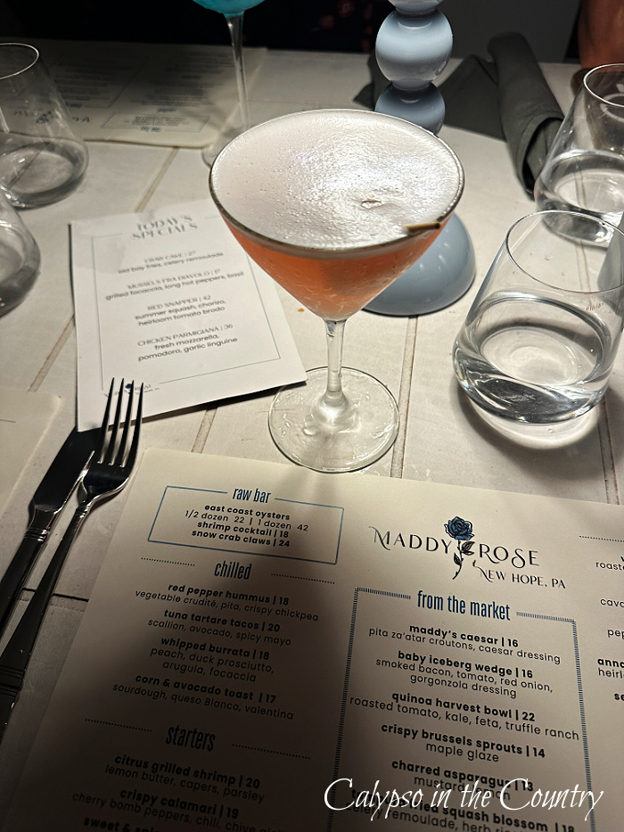 cocktail and menu on table