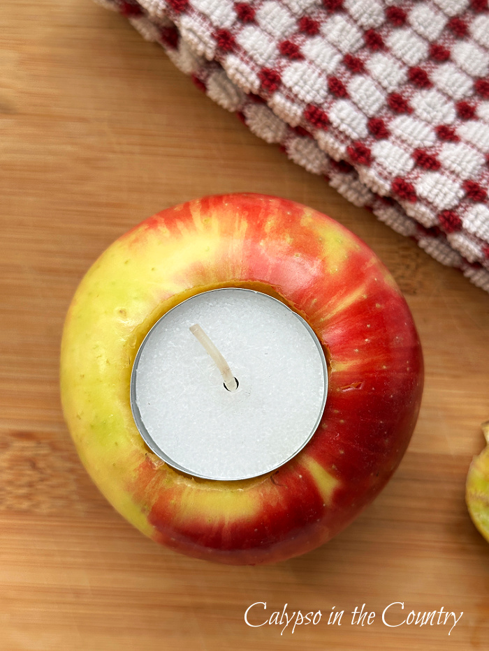 apple with tea light on wood cutting board - diy apple candle holders