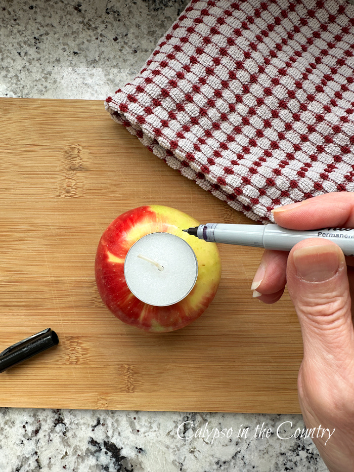 Red apple with sharpie and tealight - DIY apple candle holders