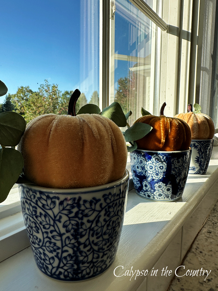 Velvet pumpkins in blue and white porcelain pots on window sill - September wrap up